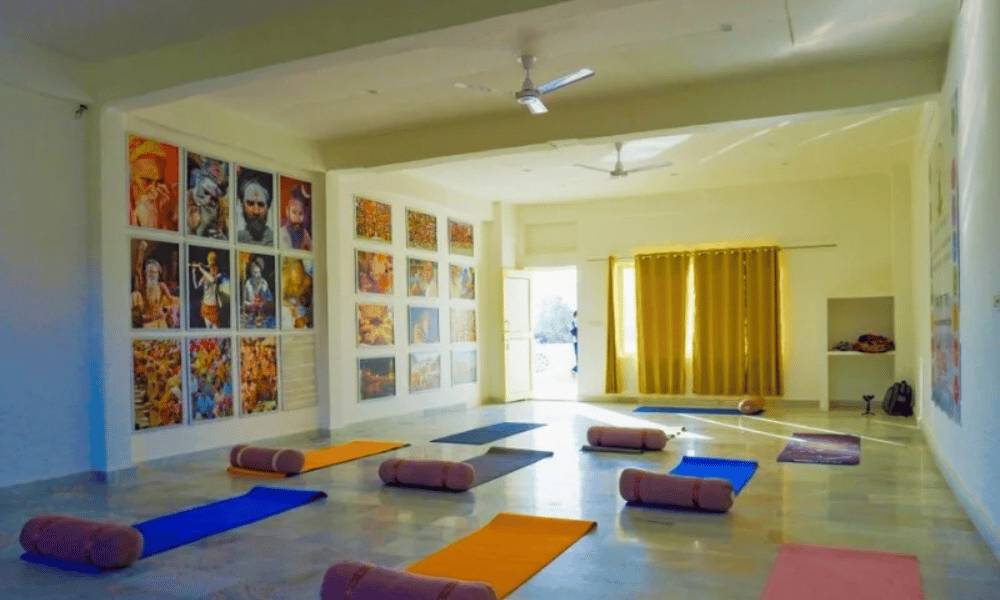 Spacious Ashram Yoga Shala Practice Hall with Mats and Props in Rishikesh