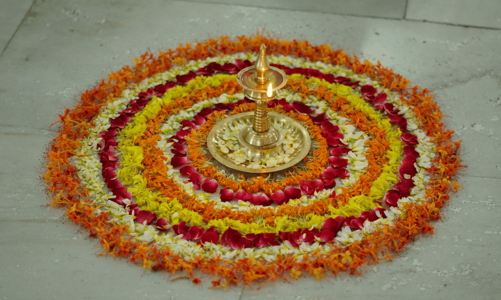 Traditional Indian Brass Diya Lamp Centered on Flower Mandala Rangoli