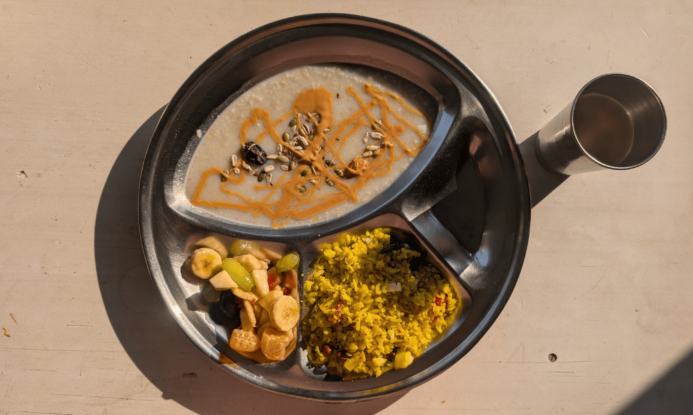 Wholesome Sattvic Breakfast Thali with Porridge, Poha and Fresh Fruits